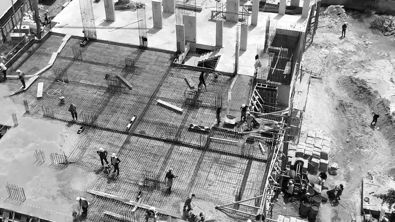 Drone photograph of Platinum Tower on 13 October 2026: crews pouring concrete over the steel of a slab