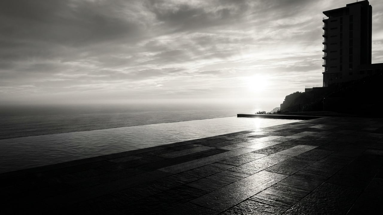 Infinity pool edge meeting the ocean horizon